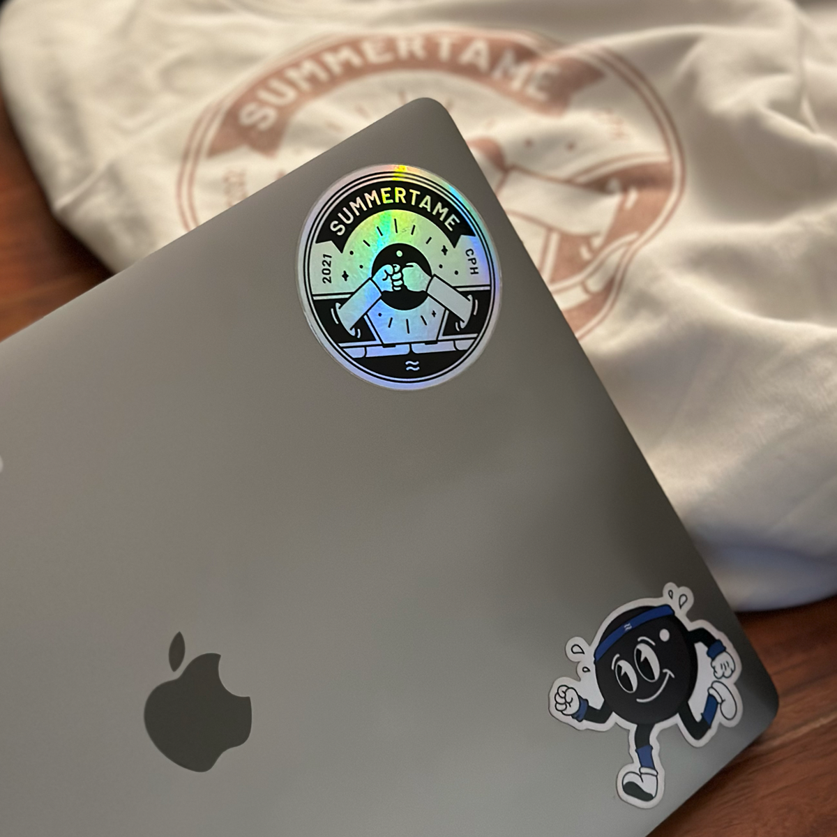 Image of a laptop with some sticker I designed.
